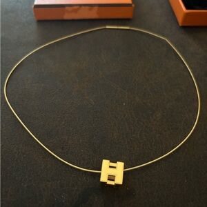 Authentic 24K gold Hérmes Cage H necklace.